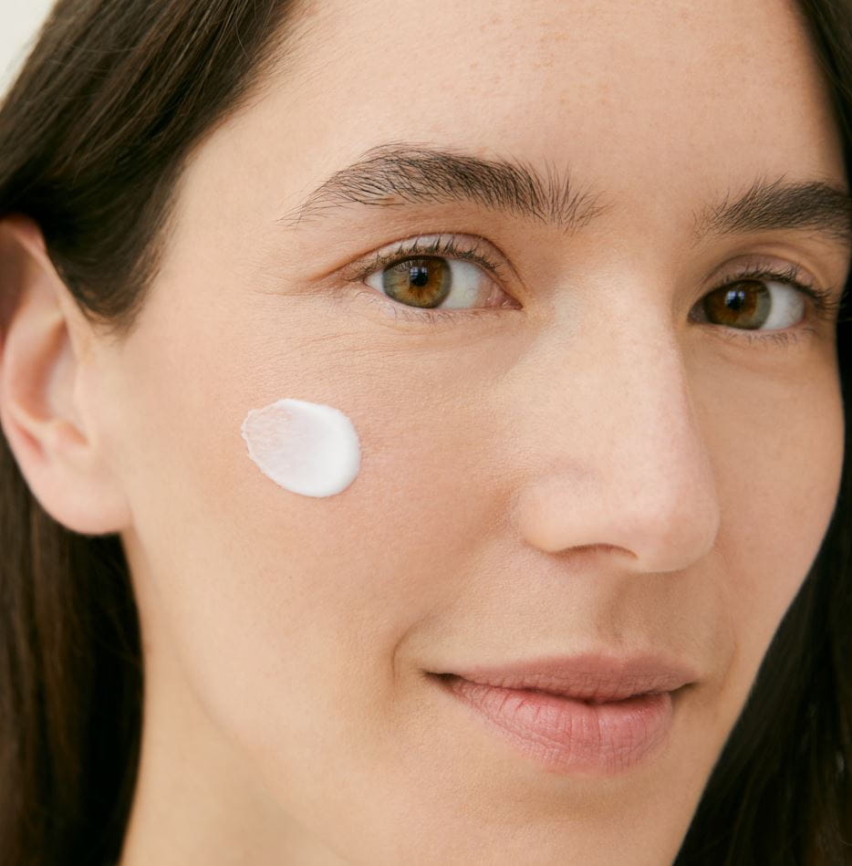 woman with day cream on her face