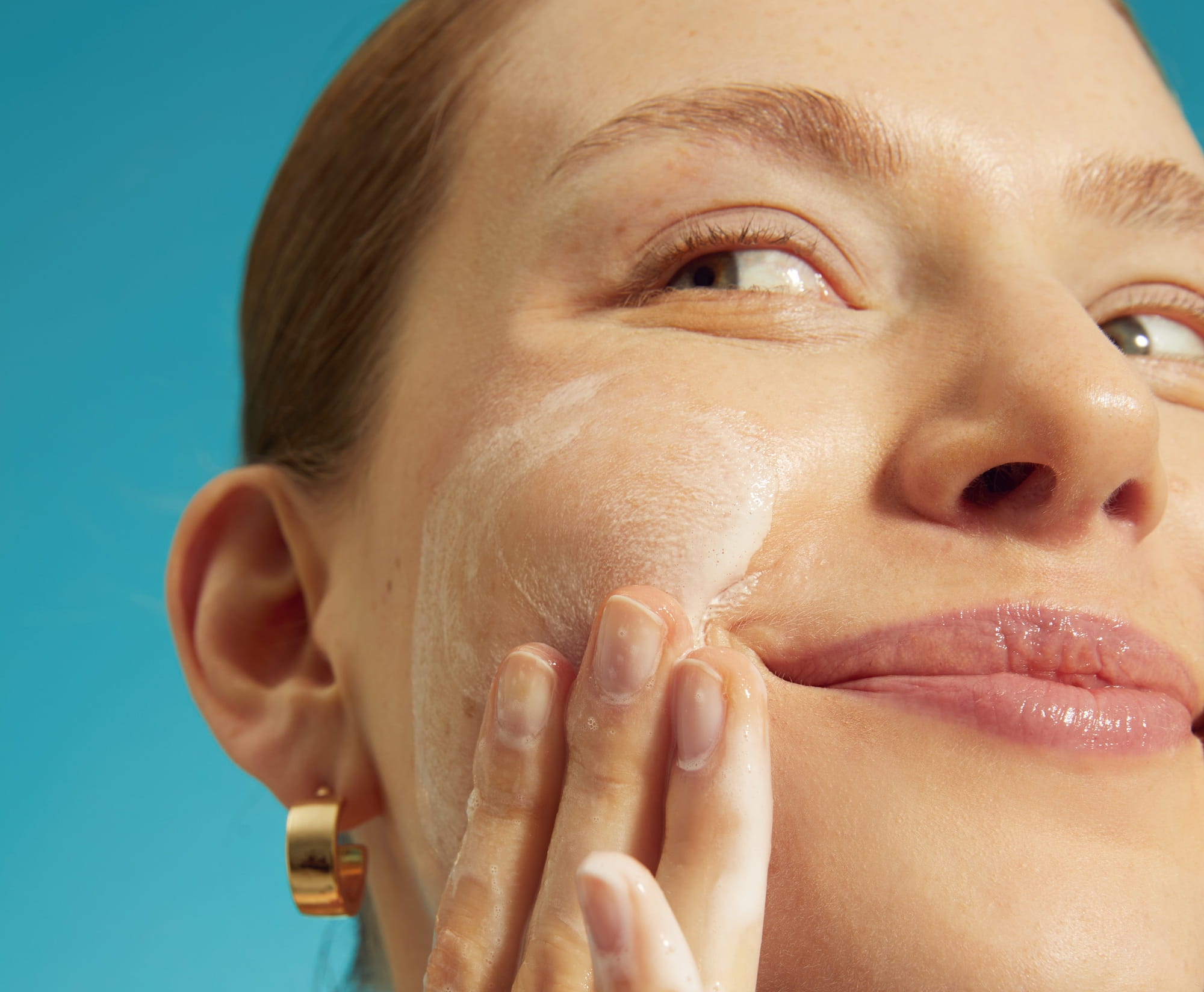 Young woman washing her face