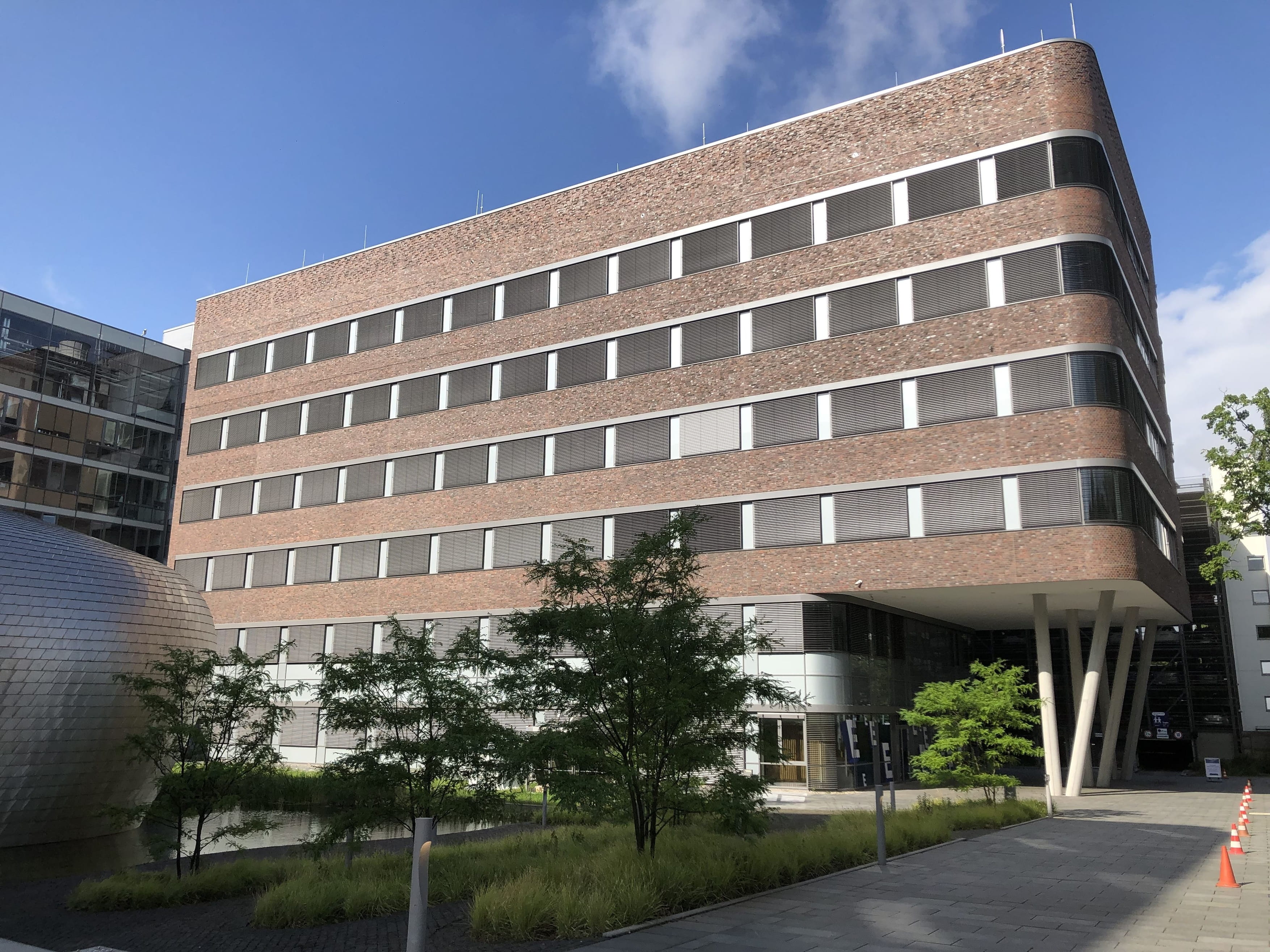 Modern office building with brick facade and large windows.