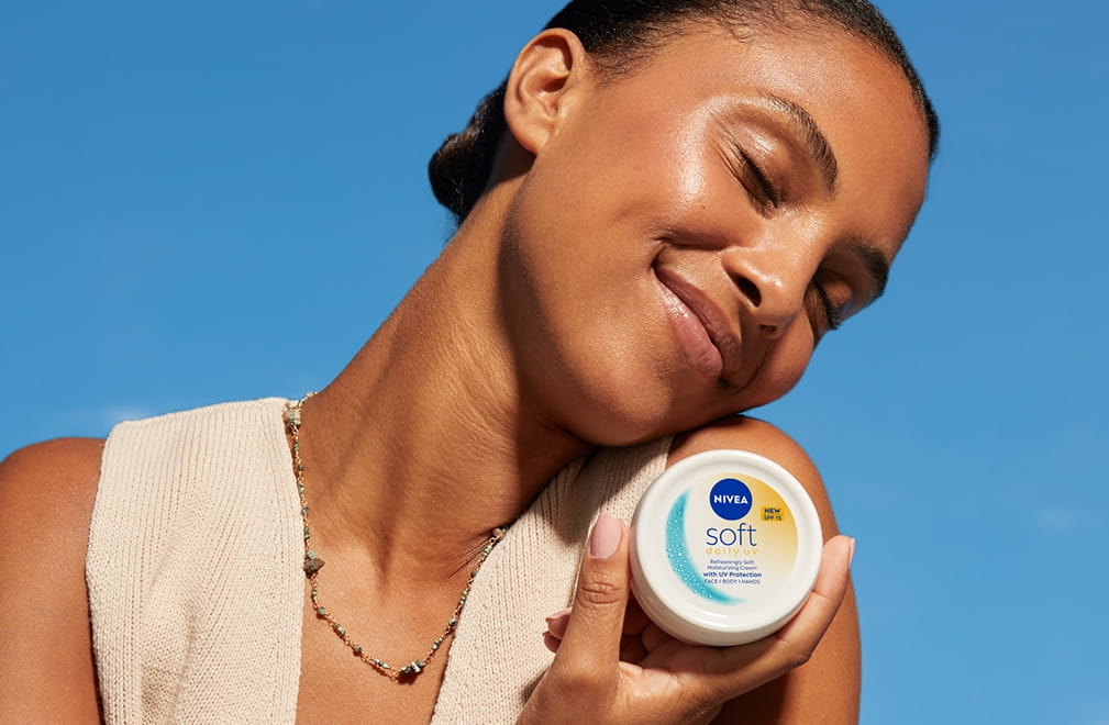 Woman using NIVEA Soft Daily UV SPF15
