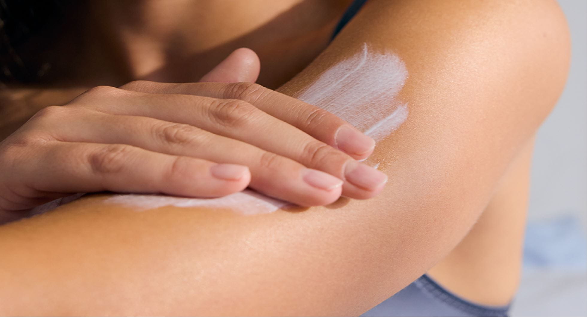 A woman moisturizing her arm with NIVEA Body Lotion