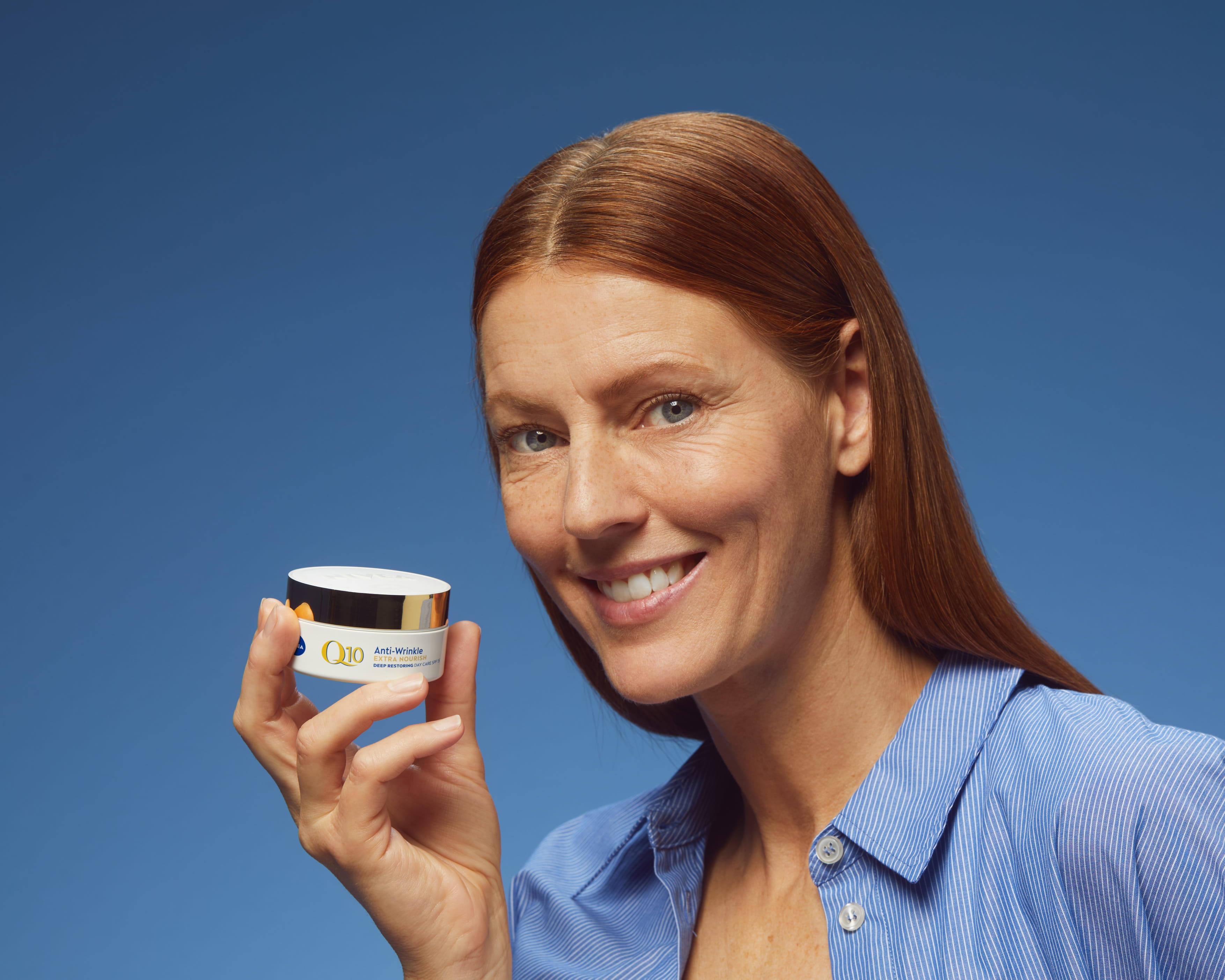 Woman using Nivea Q10 Anti Wrinkle face cream