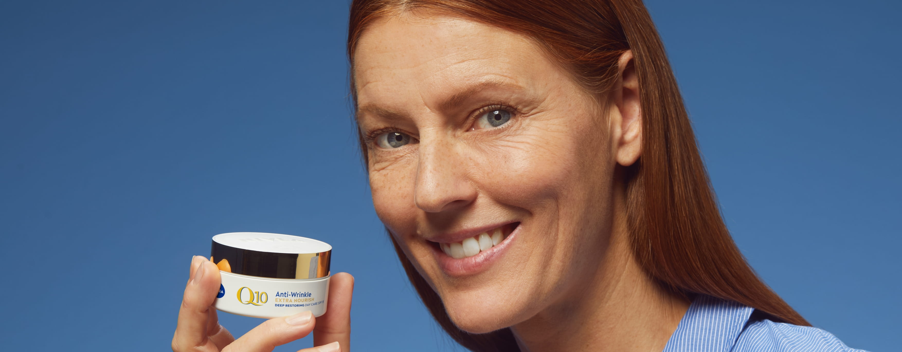 Vrouw die Nivea Q10 Anti-Rimpel gezichtscrème gebruikt