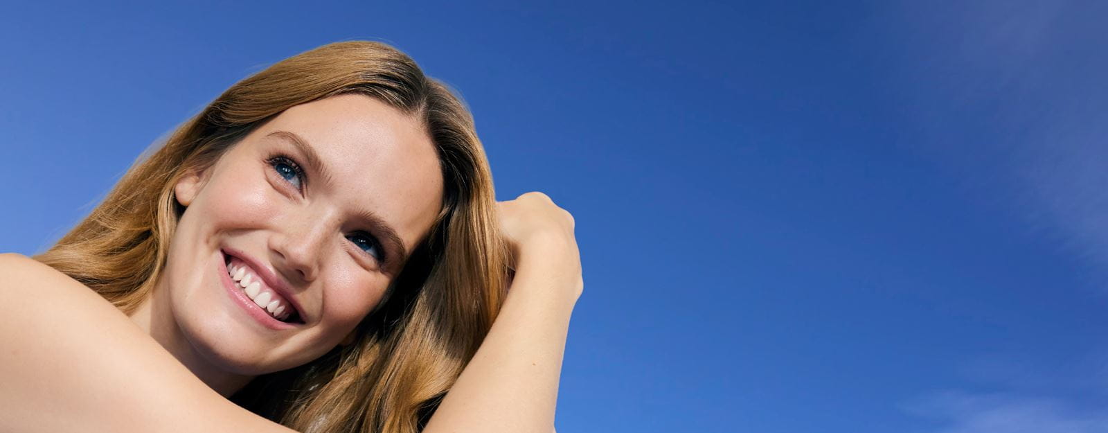 Woman with clear and glowing skin after using NIVEA Body Lotion