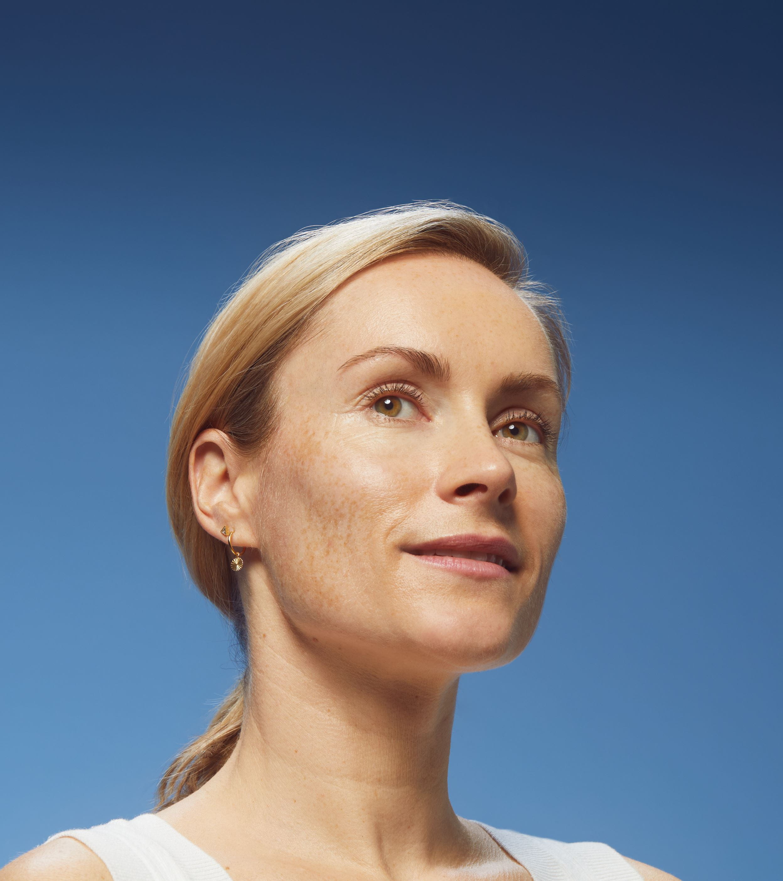 woman holding a Nivea Cellular Luminous630 face cream