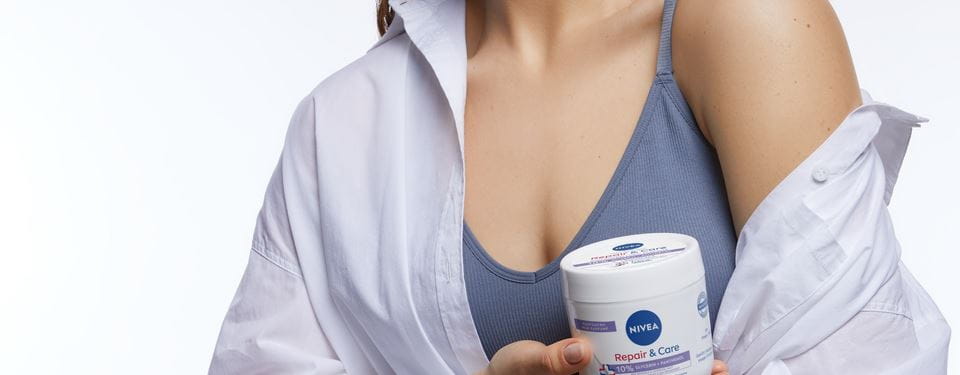 femme appliquant une lotion pour le corps sur ses jambes