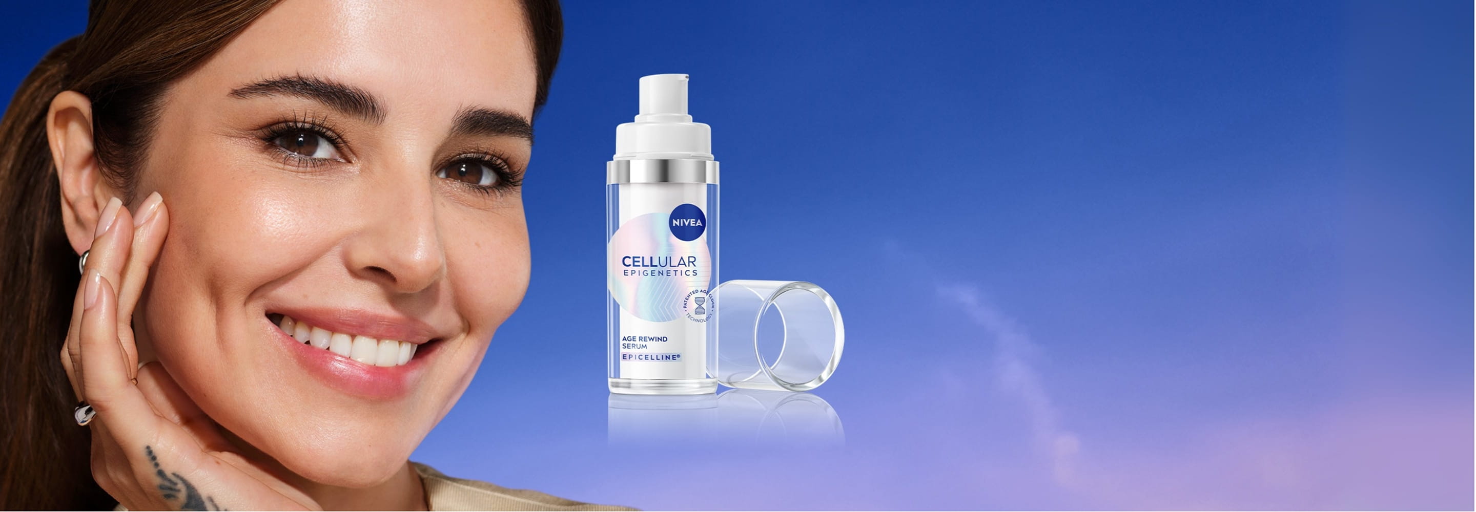 A woman touches her cheekbone area, featured next to a bottle of NIVEA CELLULAR Age Rewind Serum.