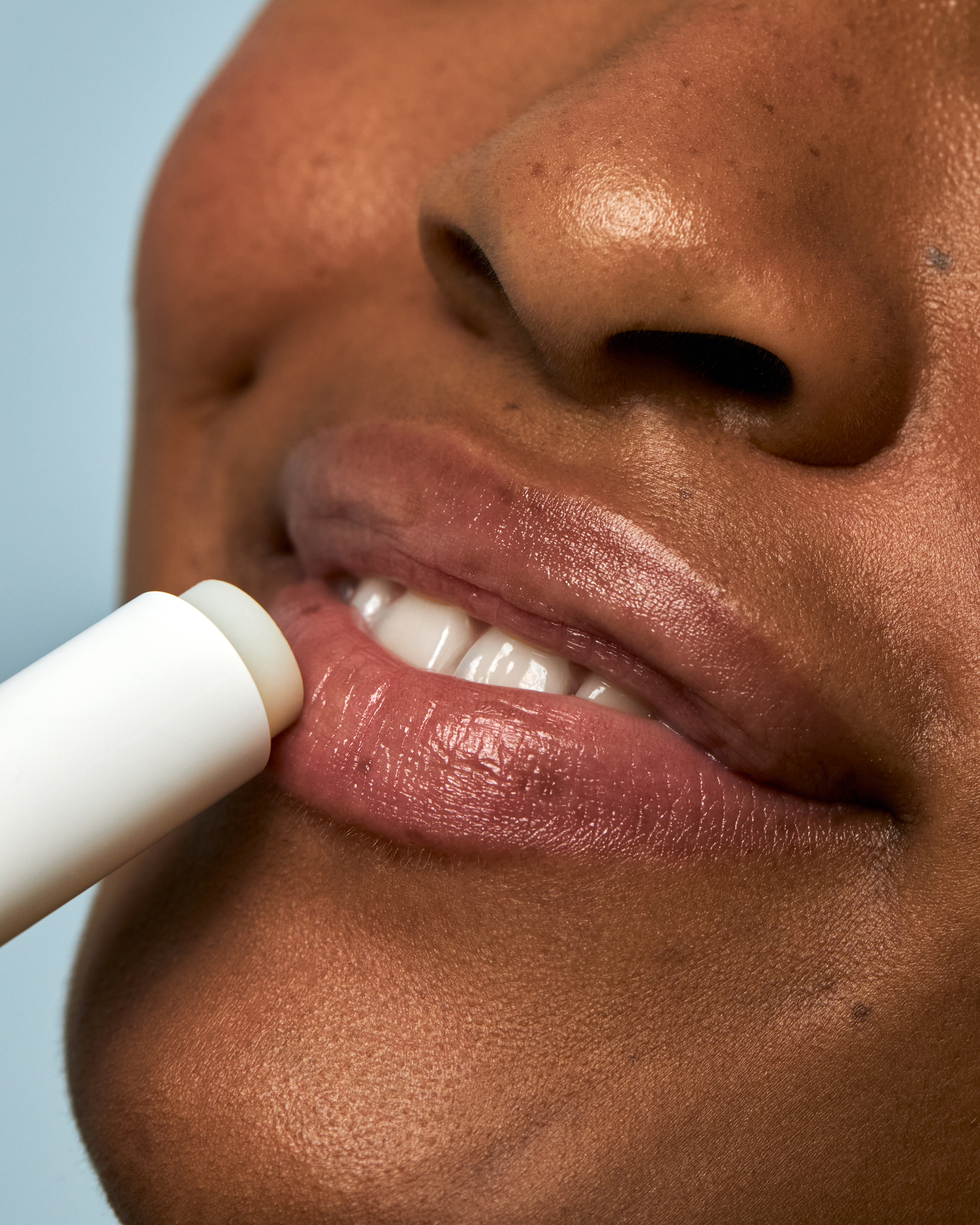 Woman applying lip balm