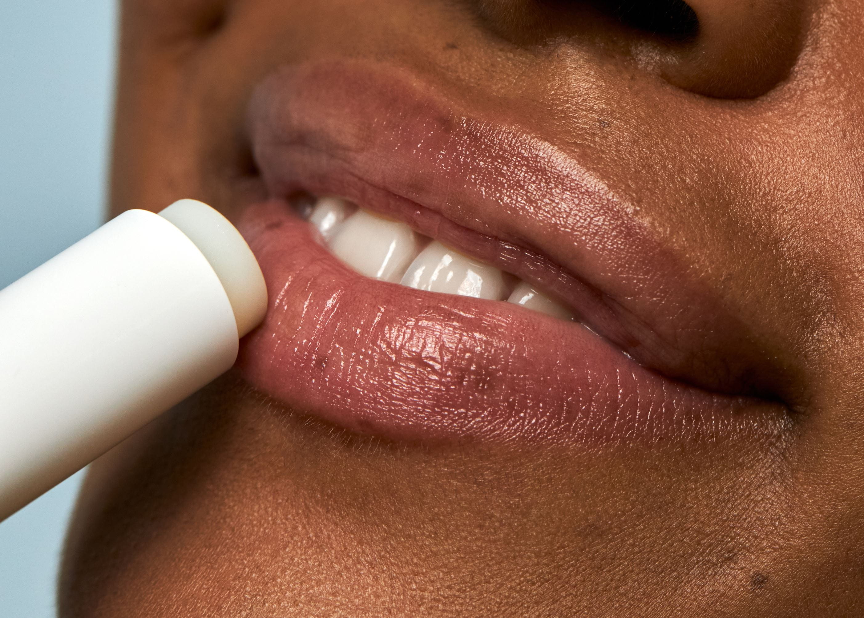 Woman applying lip balm