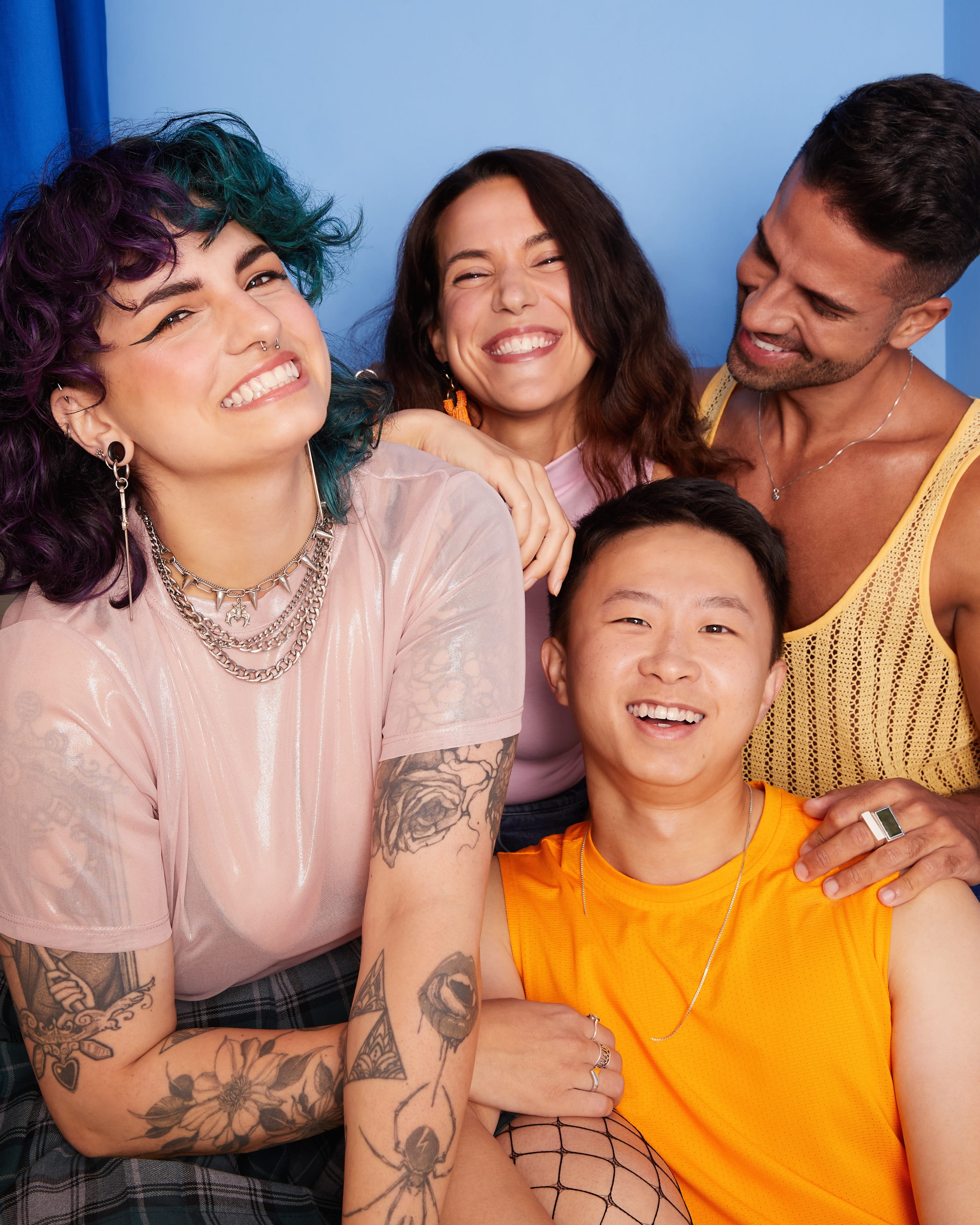 A group of four young people smiling at the camera