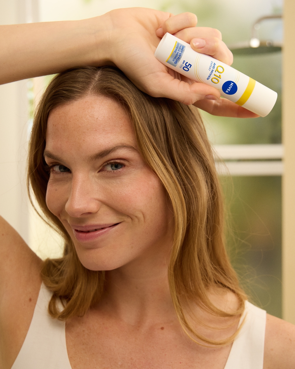 Žena používajúca Nivea Q10 Anti-Wrinkle EXPERT DAILY UV FLUID SPF 50