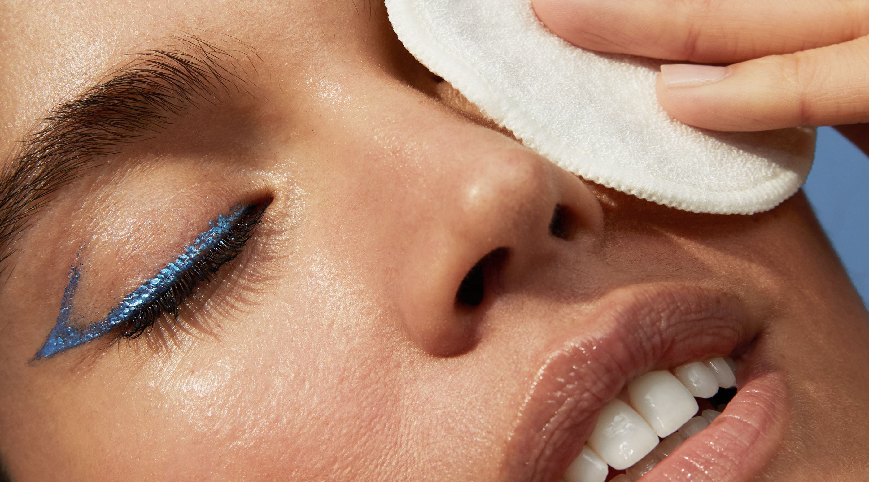 young woman taking her make up off