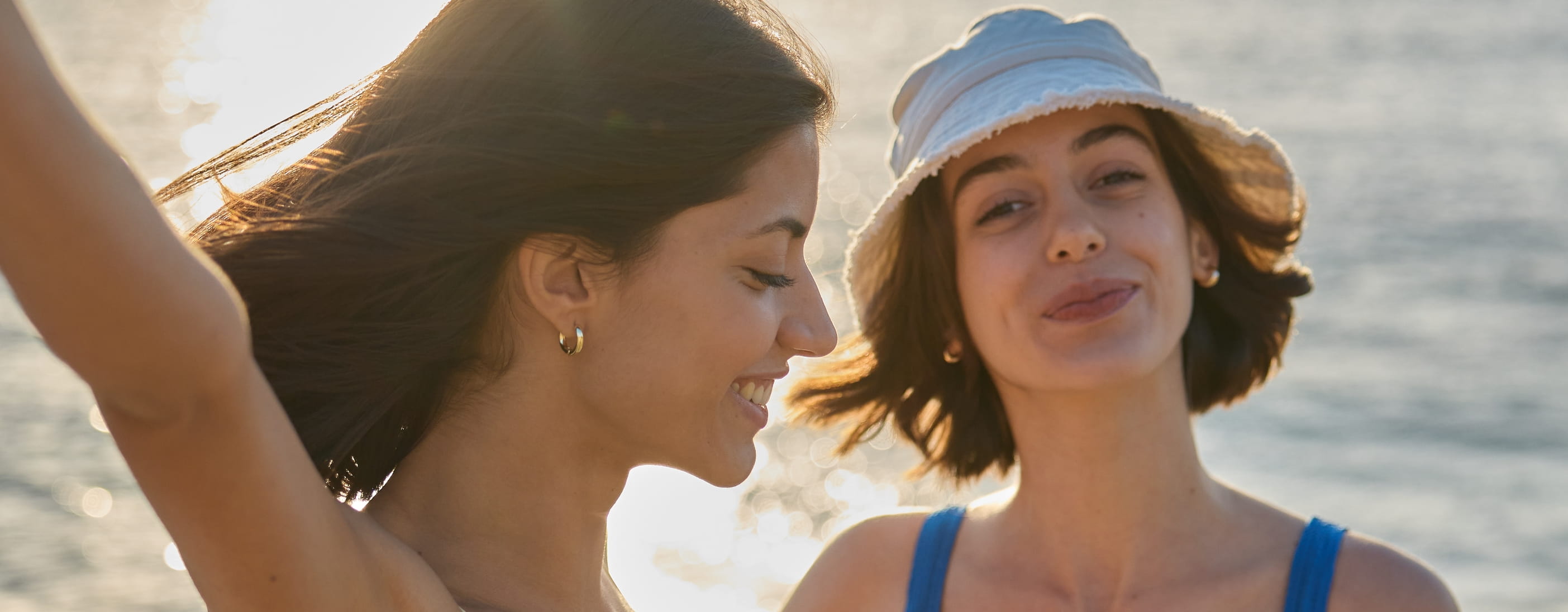 two young women standing in sun