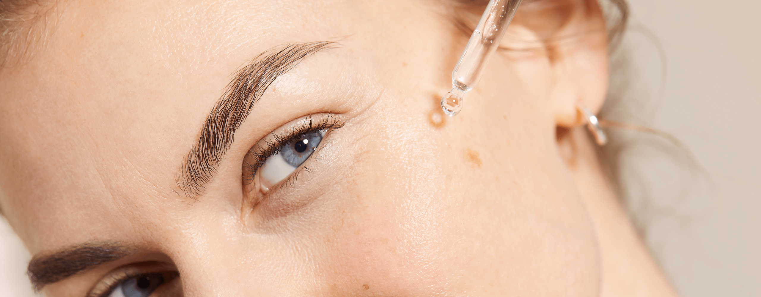Ginger hair woman holding a Nivea Q10 face cream