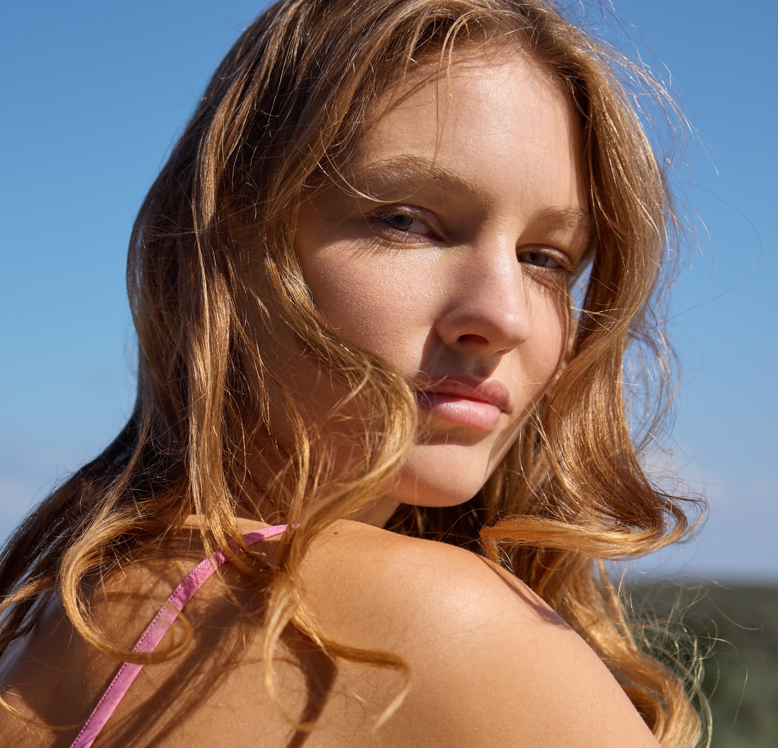 Woman outdoors showing skin exposed to sunlight, illustrating sun-related skin damage