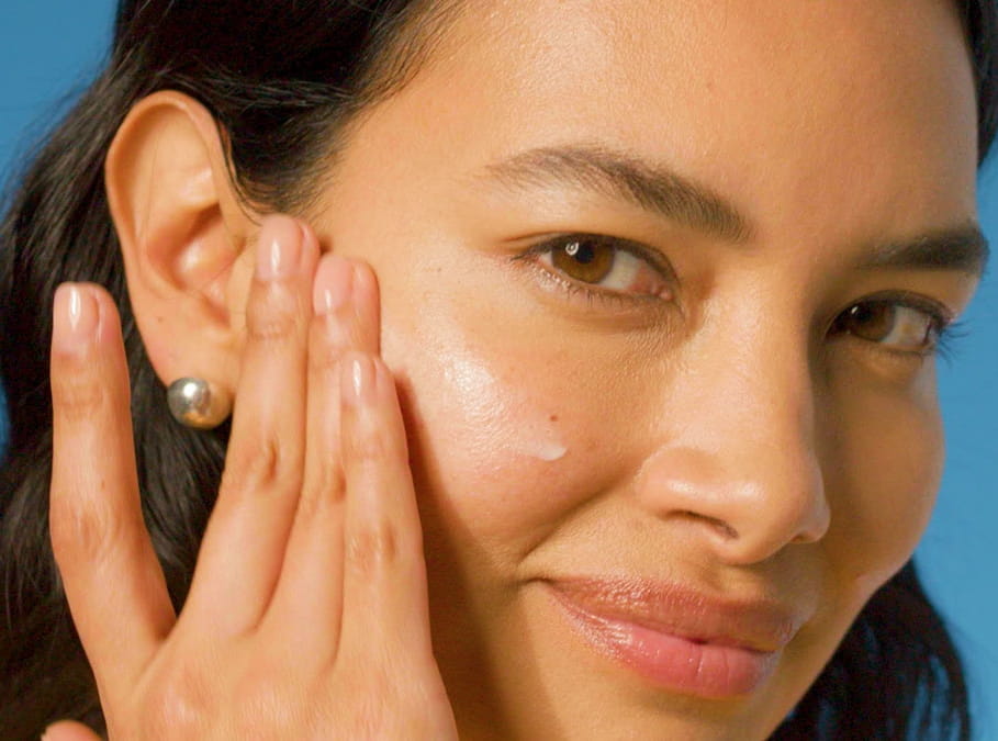 women applying moisturiser