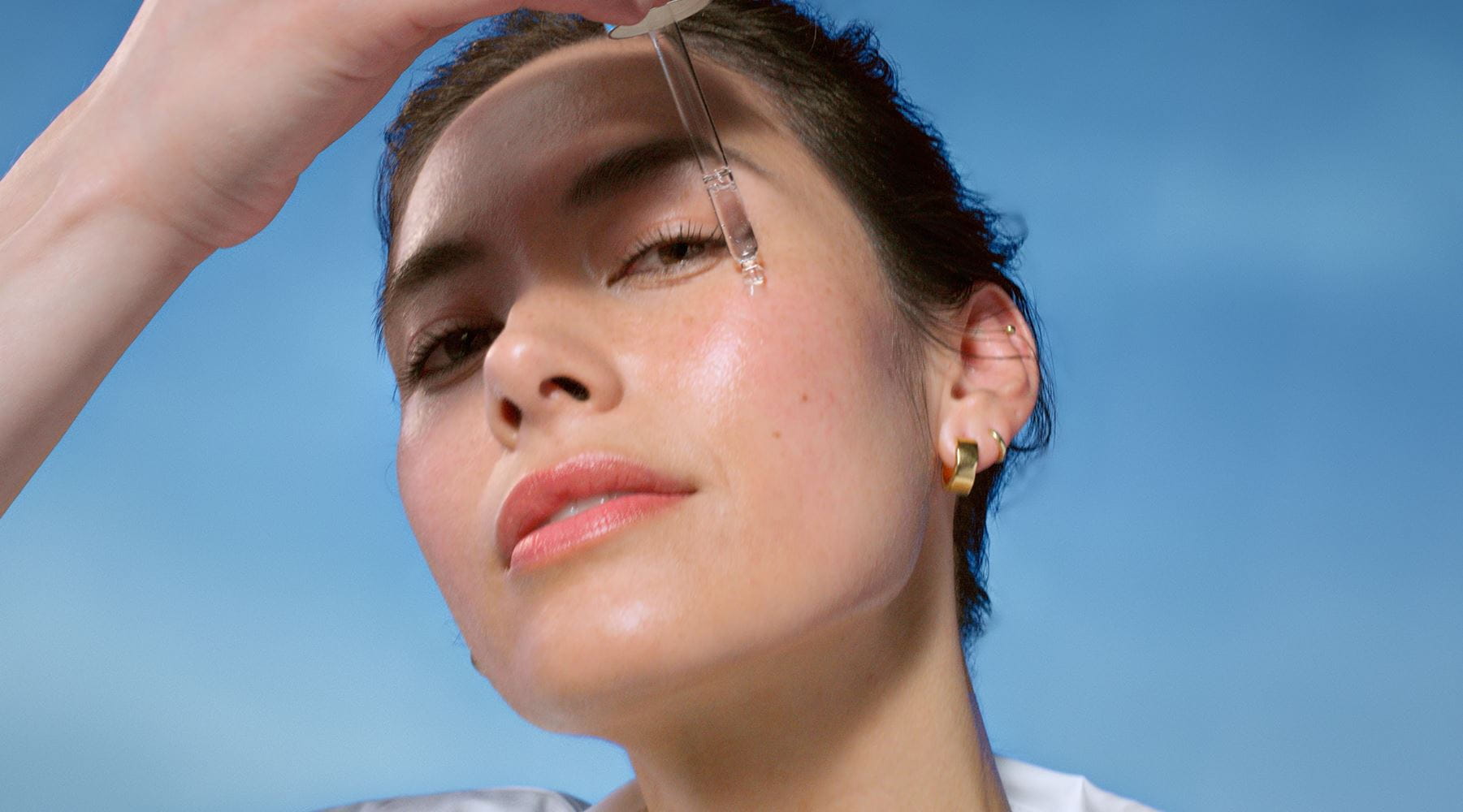 Woman applying face serum