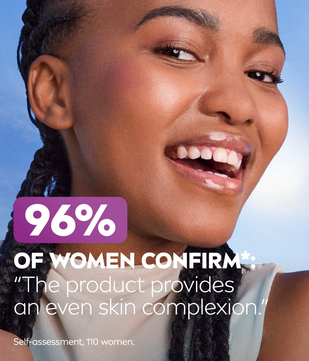 Young woman smiles and gazes, showing the glowing skin complexion and contours of her face, with text about "even skin complexion".