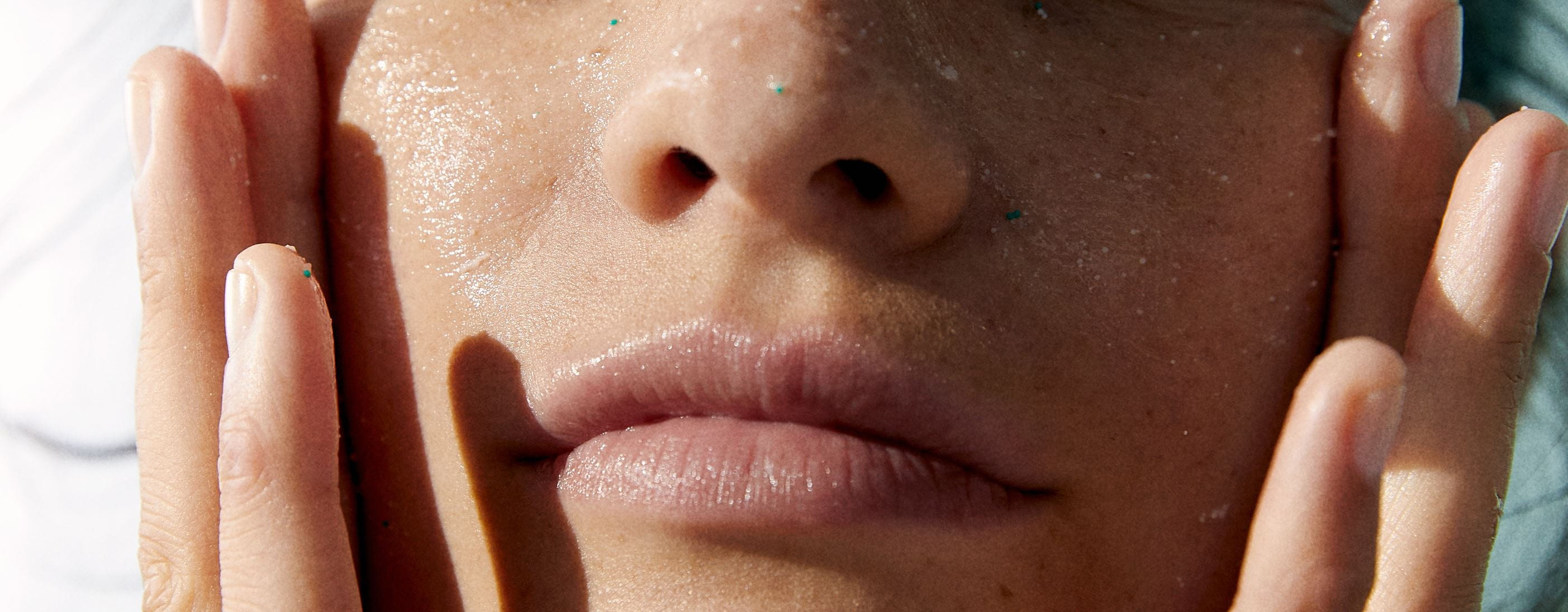 woman applying sunscreen to face