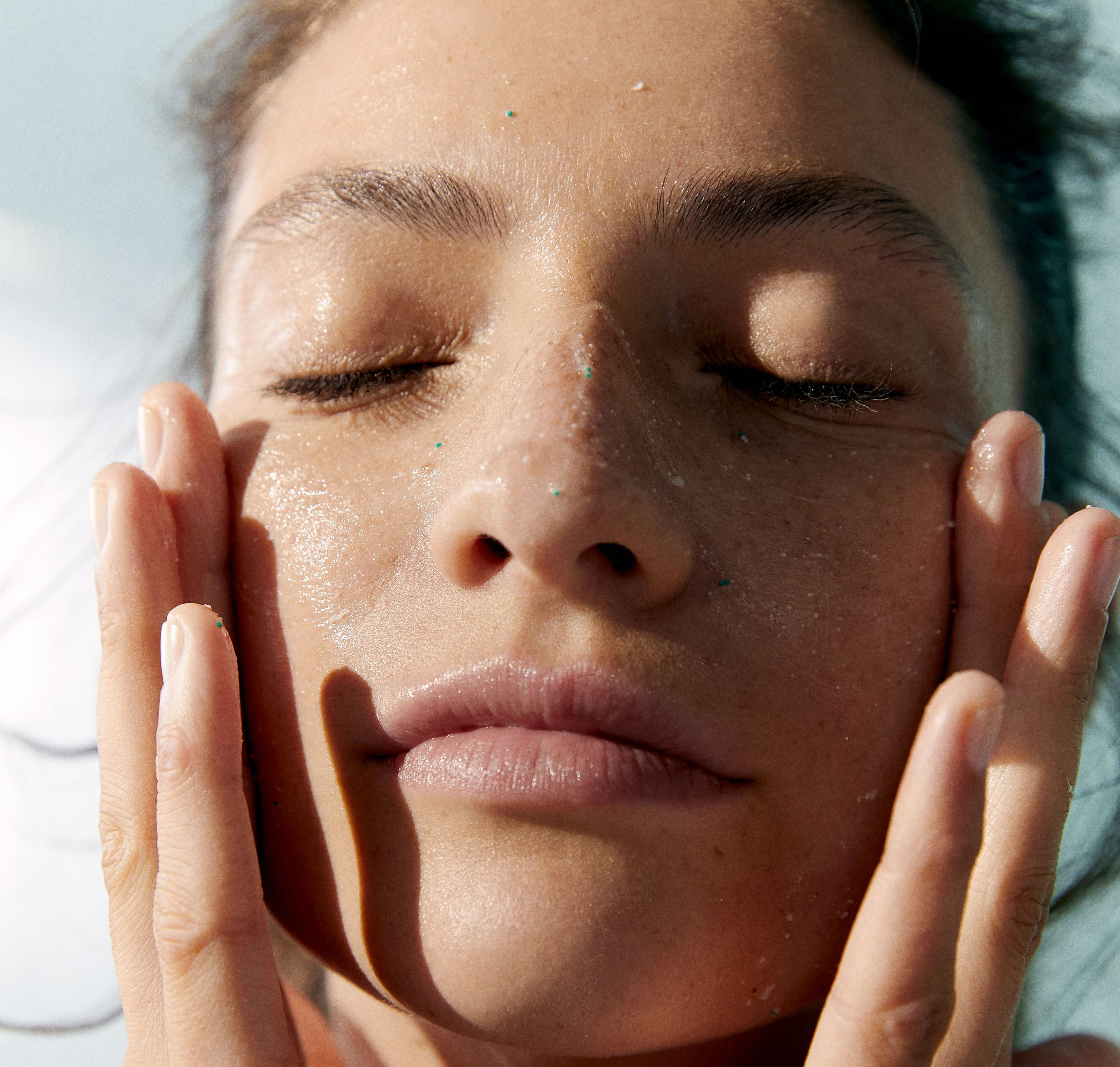 nainen koskettaa kasvoja