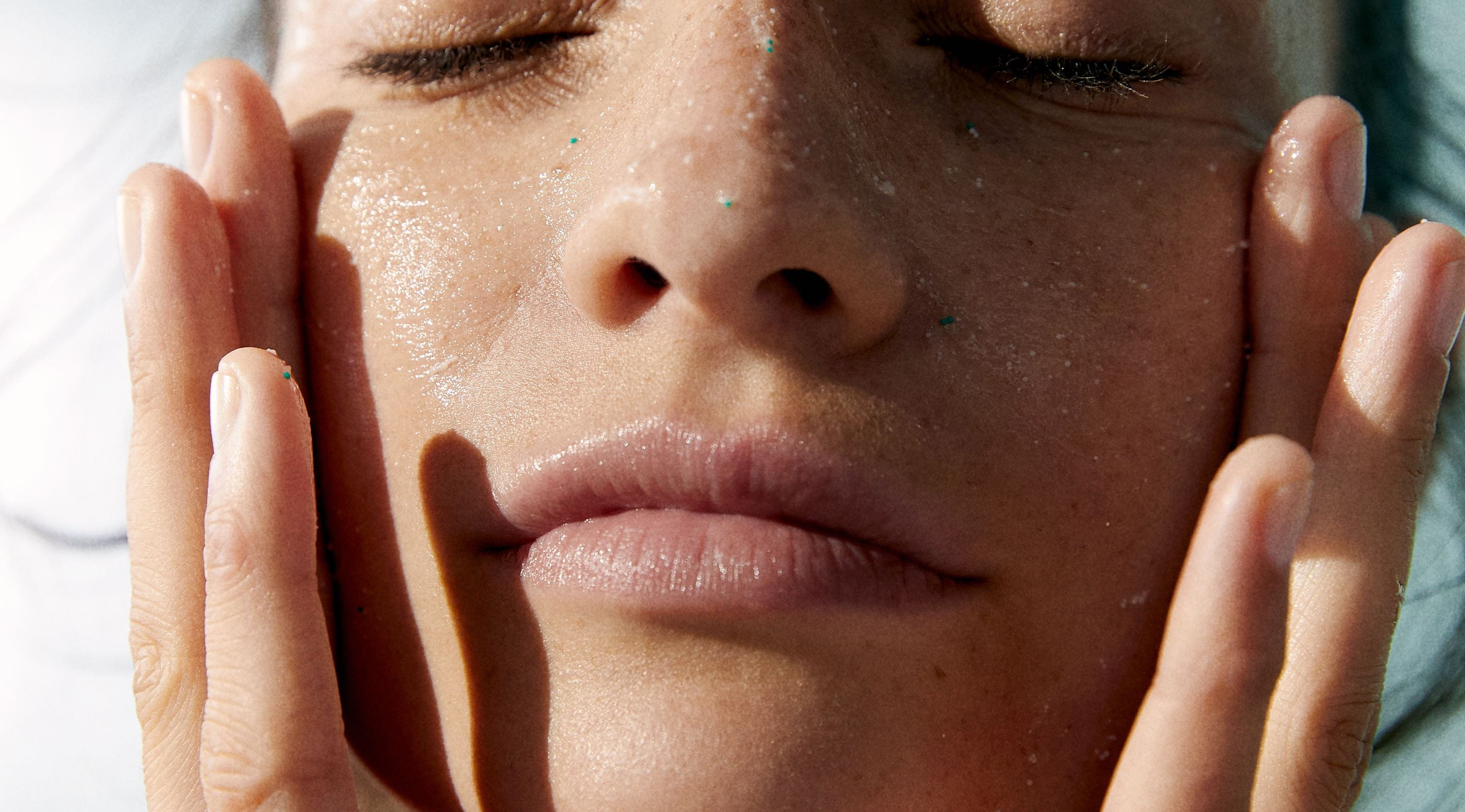 woman applying sunscreen to face