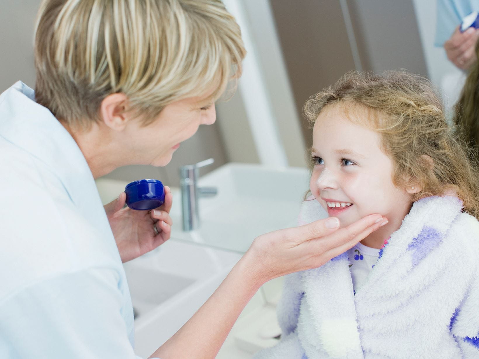 woman applying best childrens sun cream to daughter