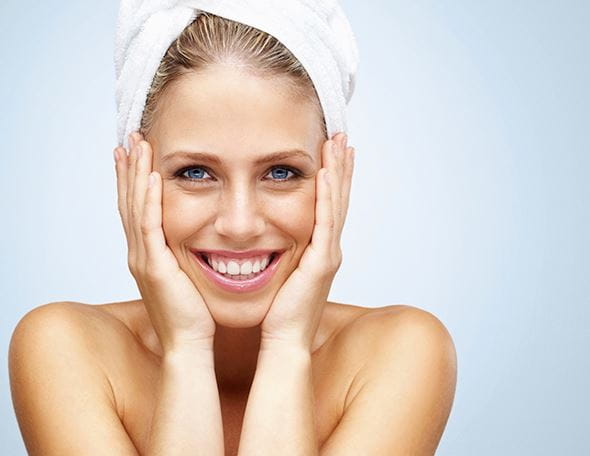 woman with hydrated skin and wearing towel on head