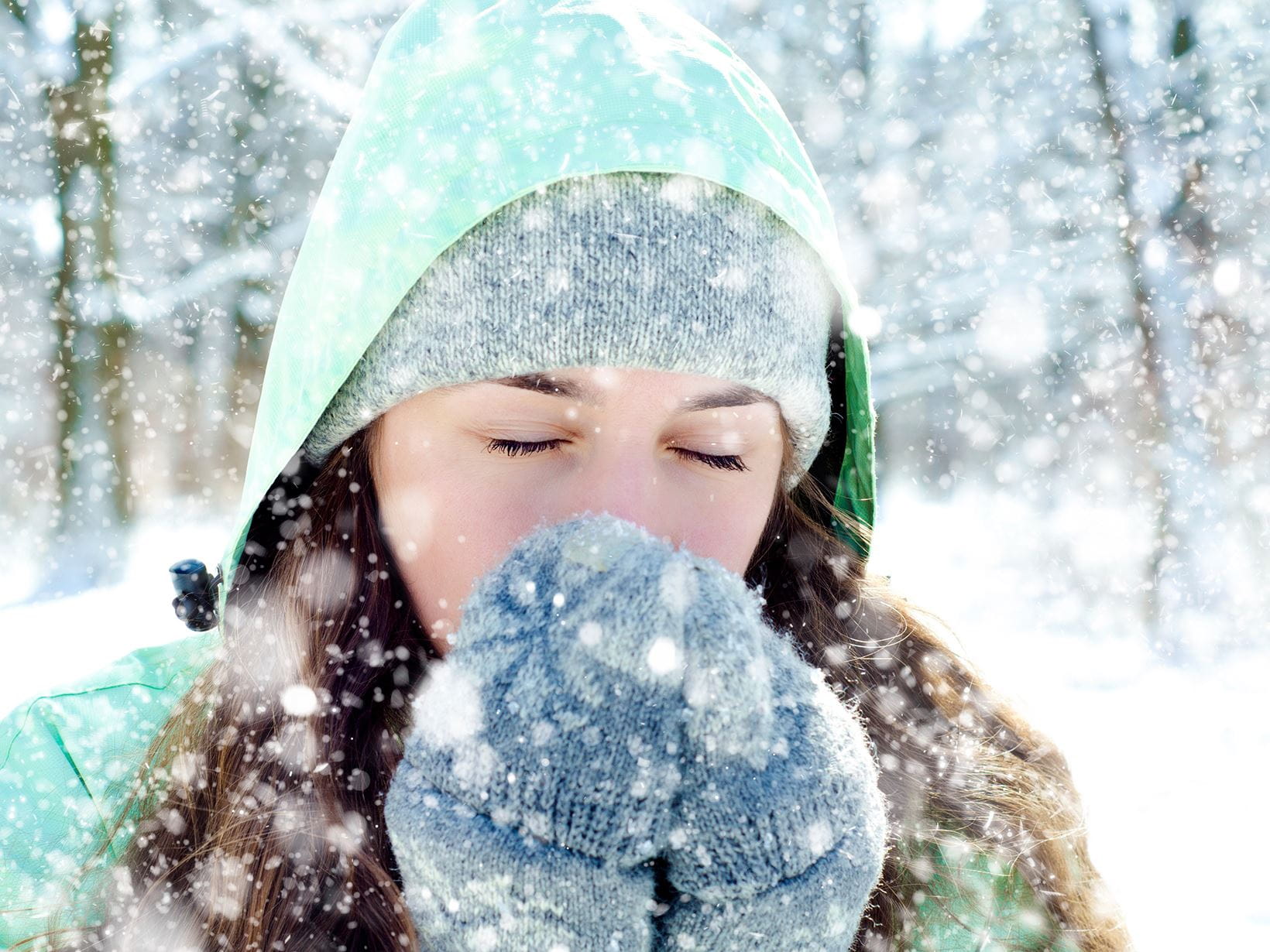 brunette lady with gloves standing in snow