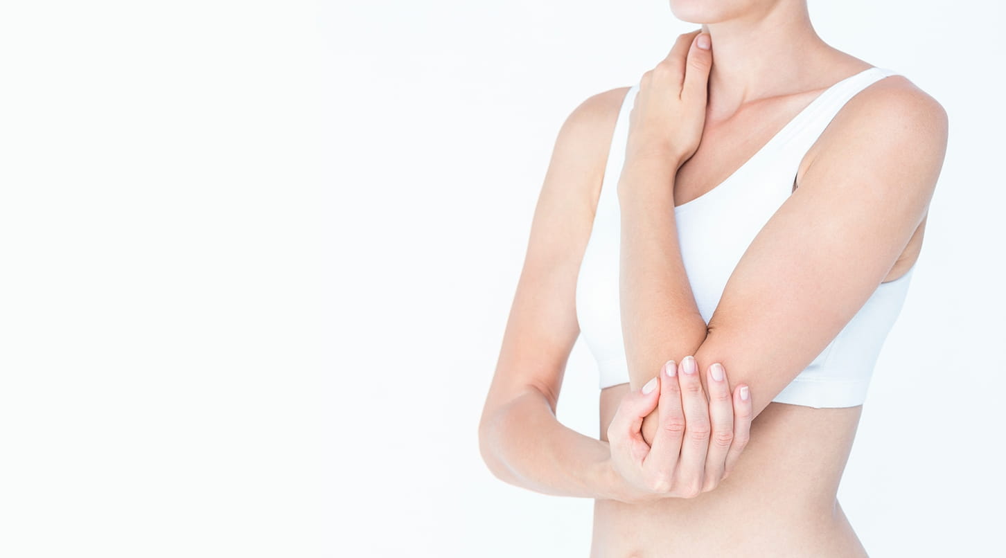 woman holding her elbow