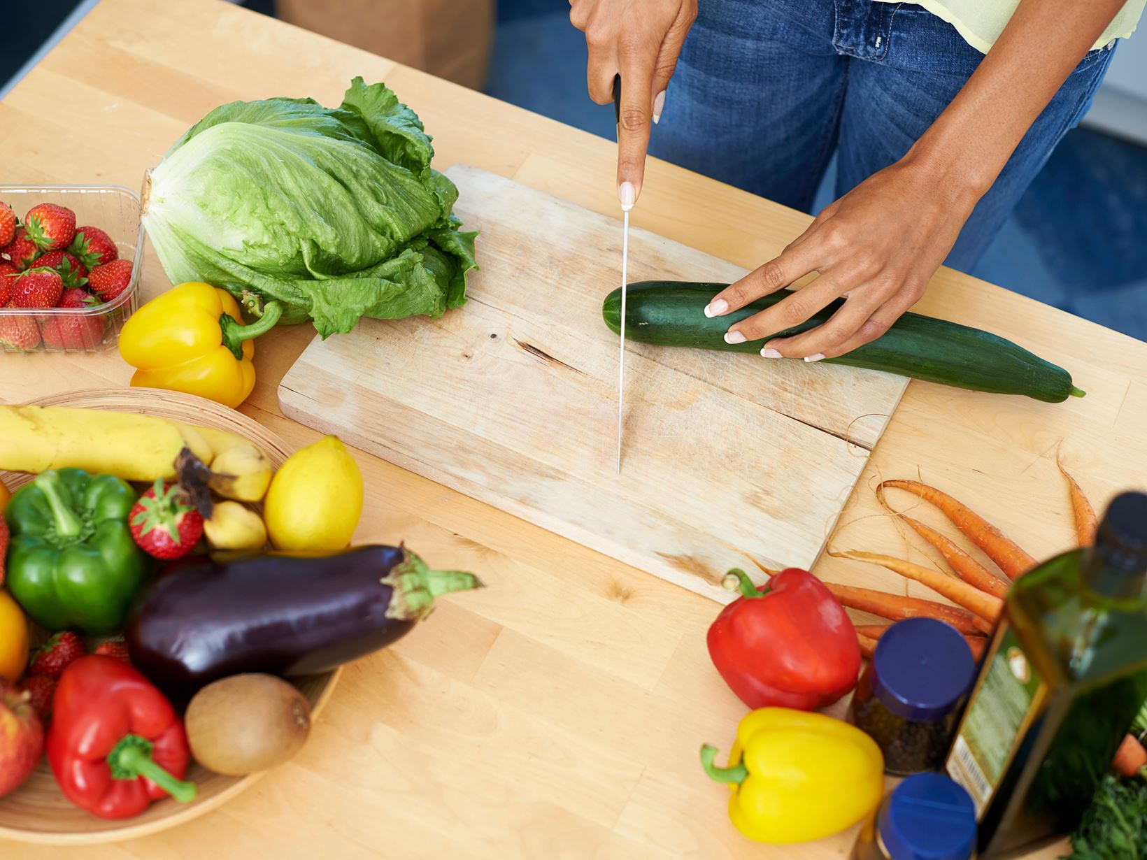 woman preparing salad with fruits and vegetables