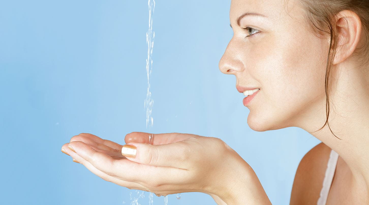 water falling into womans hands