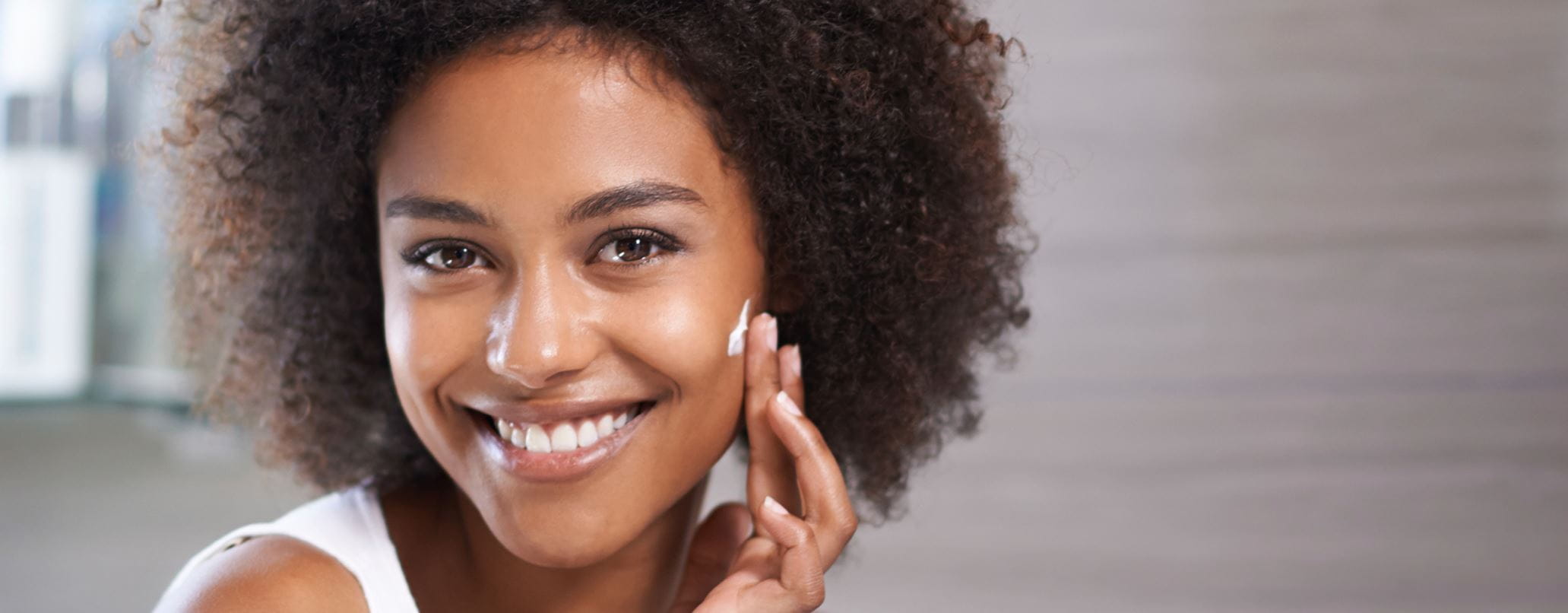 woman moisturising face