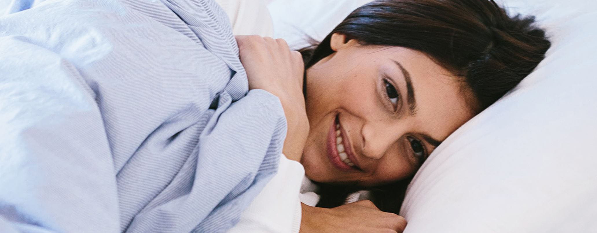 Frau liegt im Bett