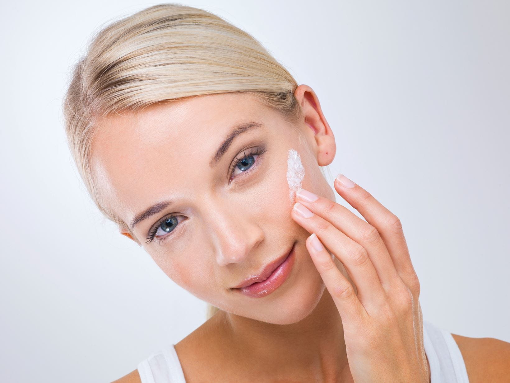 woman applying day cream