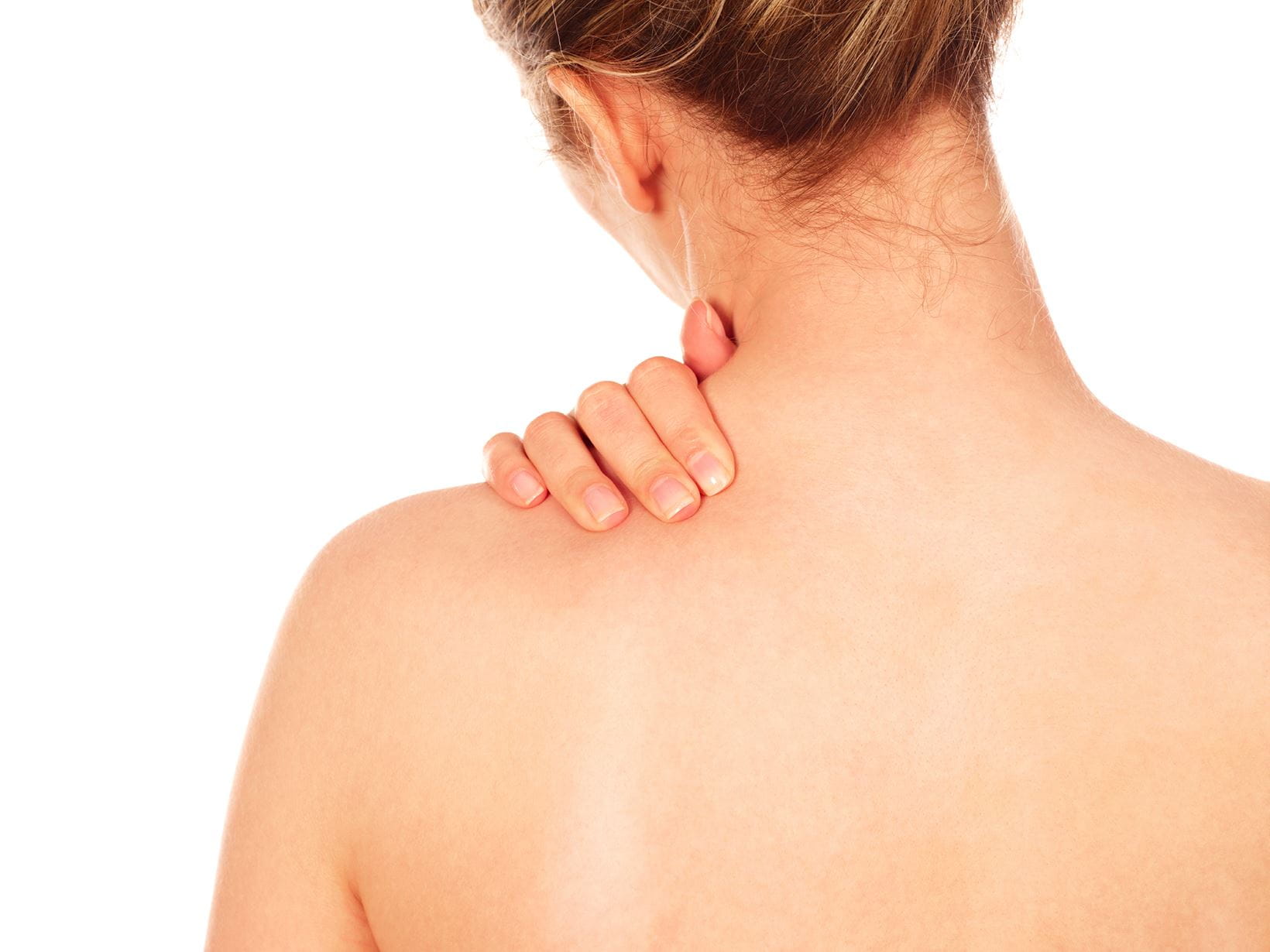 lady massaging fake tan into her shoulder with one hand