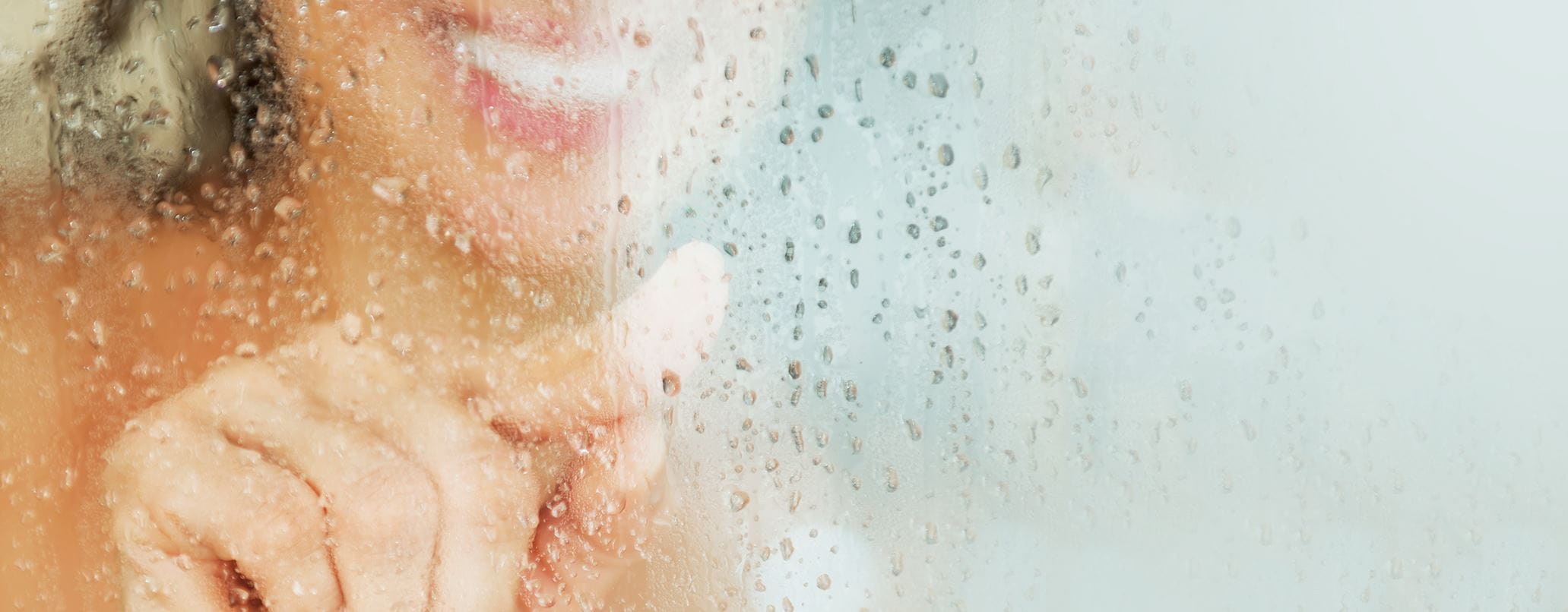 woman-behind-glass-shower-door-header