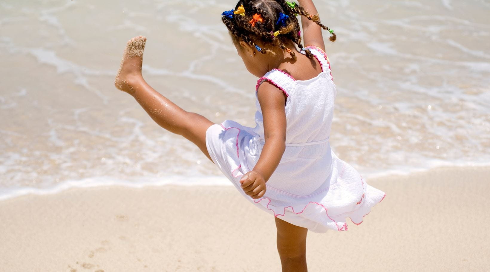 kid playing in the sand