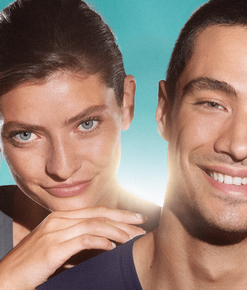 Close up of a woman and man, both of their faces show clear, blemish-free skin. They