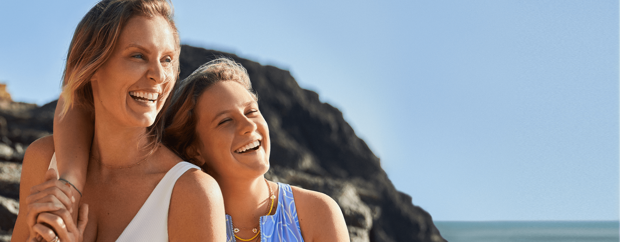 The image represents two women, happy to be ready for the summer sun with Nivea sun protection creams