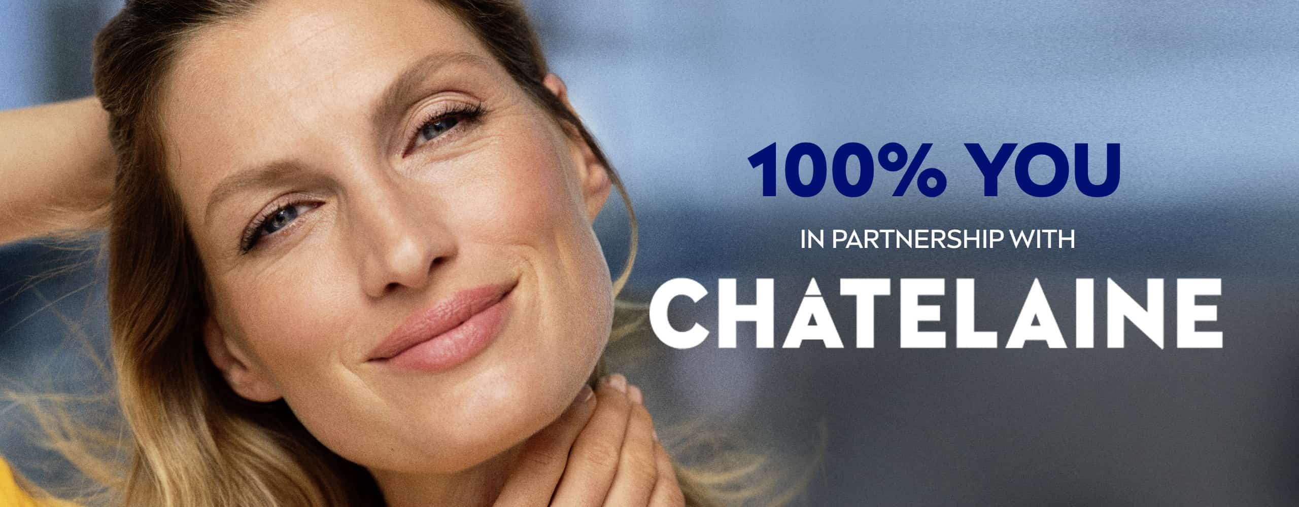 Front view of a female model with blonde hair and blue eyes smiling against a blue background.