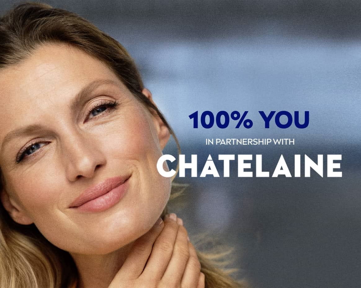 Front view of a female model with blonde hair and blue eyes smiling against a blue background.