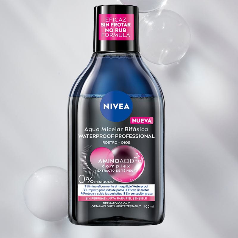 A bottle of NIVEA Micellar Water for Normal Skin lays on a blue bubble textured background.