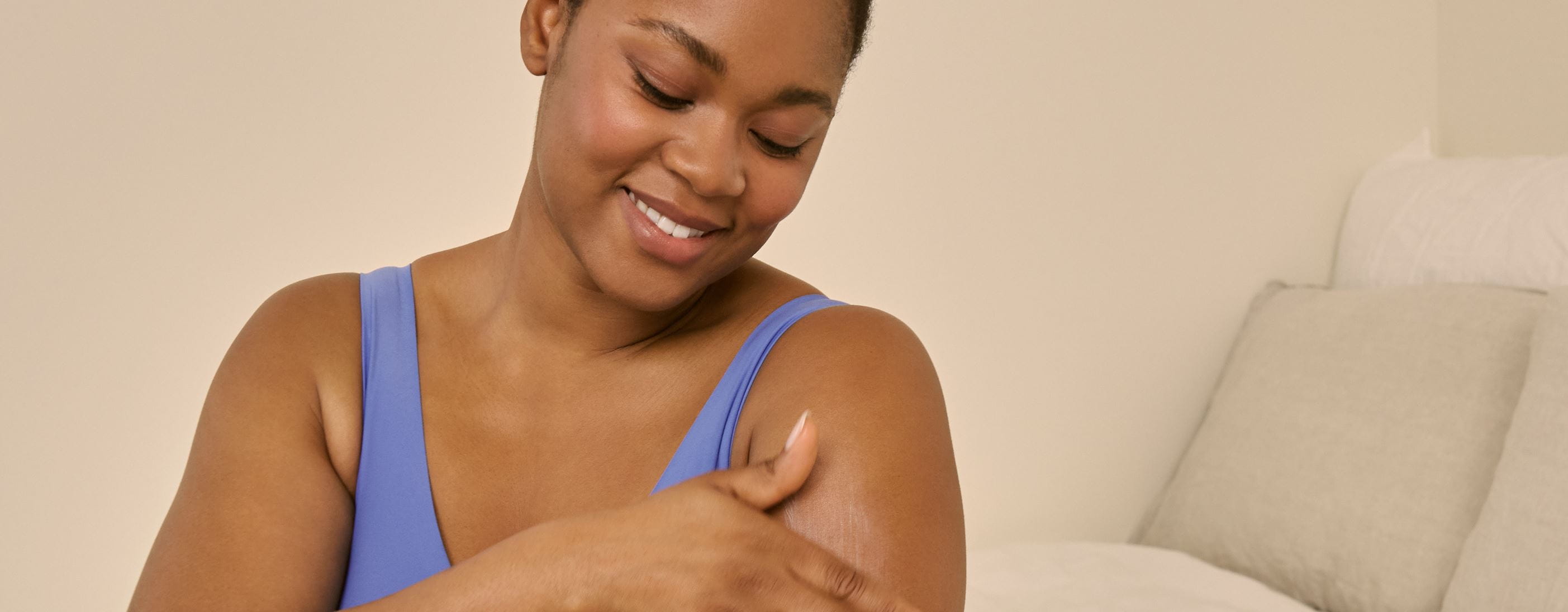 woman using Nivea body cream