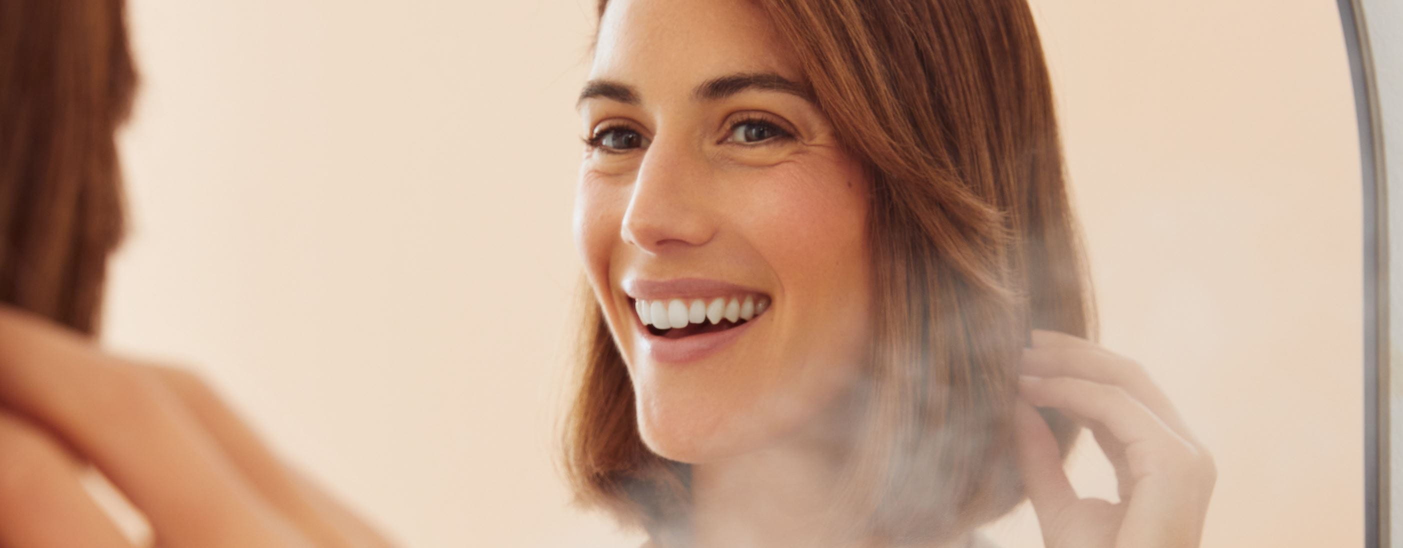 Junge Frau benutzt Nivea-Haarspray
