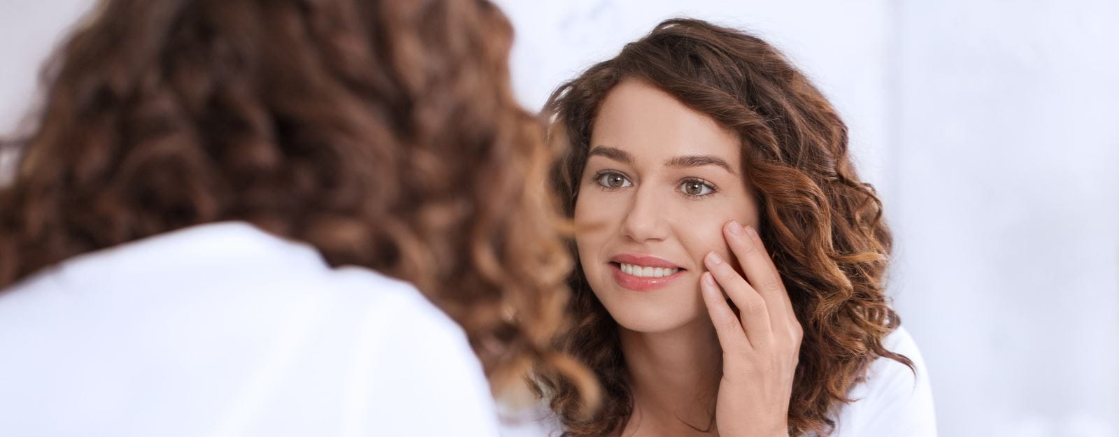 woman looking at eye wrinkles