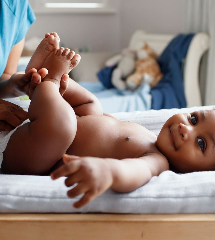 Mutter wechselt die Windel ihres Babys