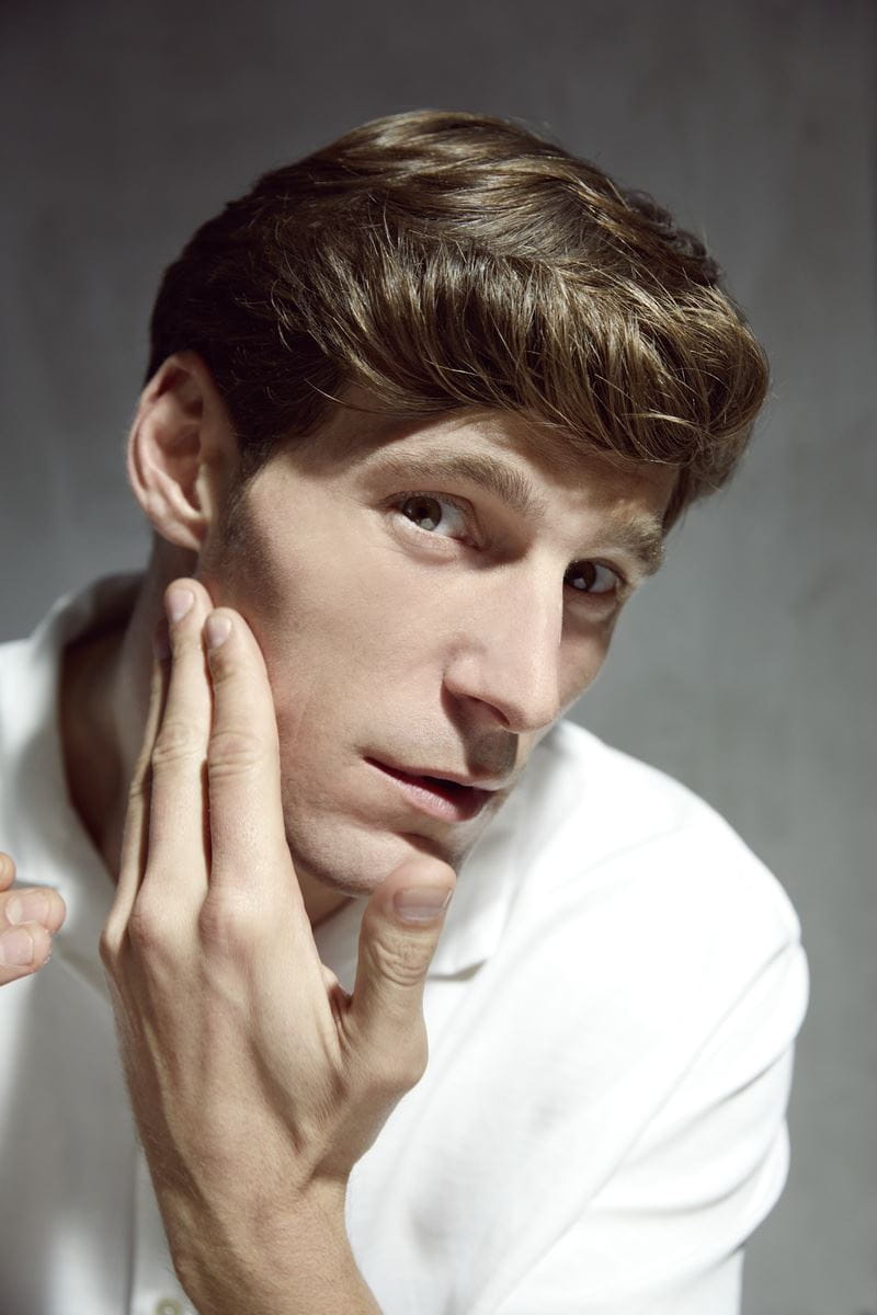 man touching his face