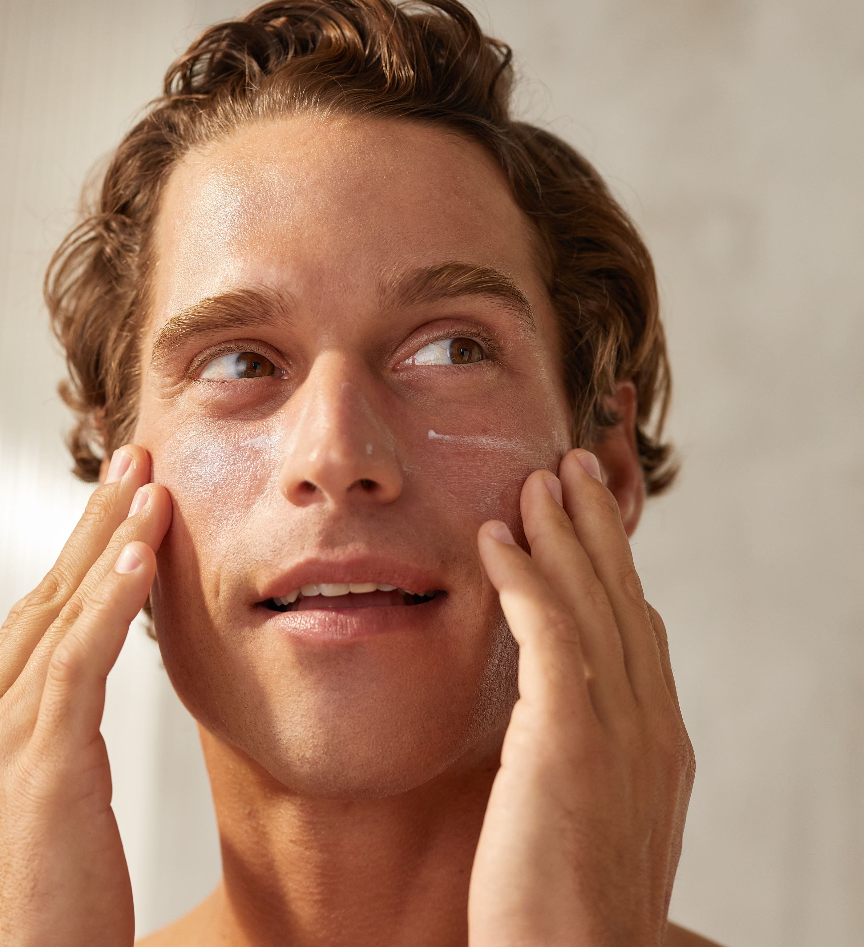 man applying Nivea face moisturise cream