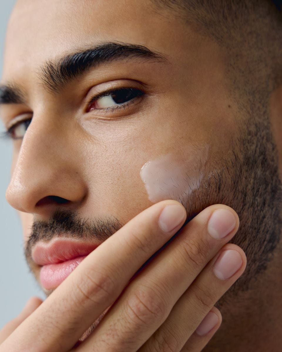 young man applying Nivea washing gel on his face