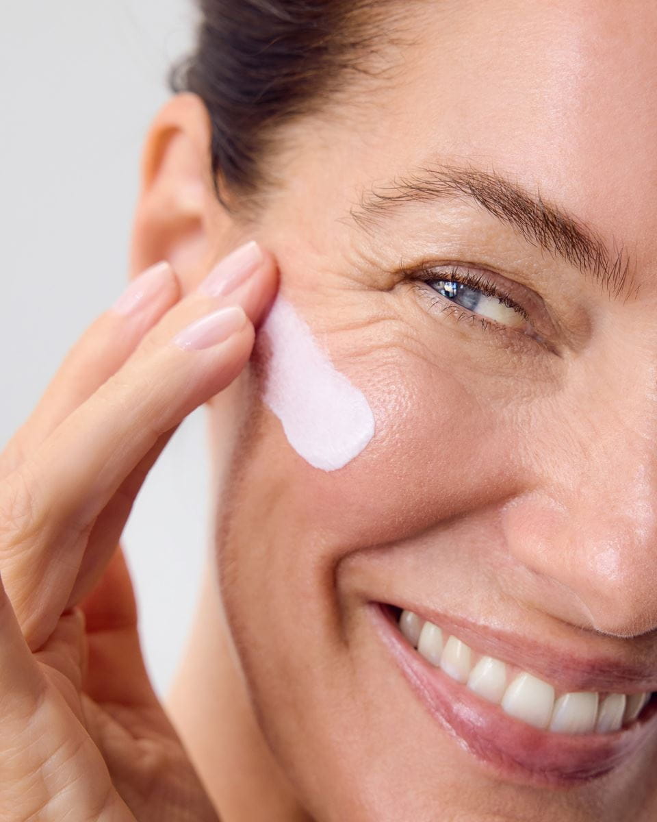 woman applying Nivea face cream